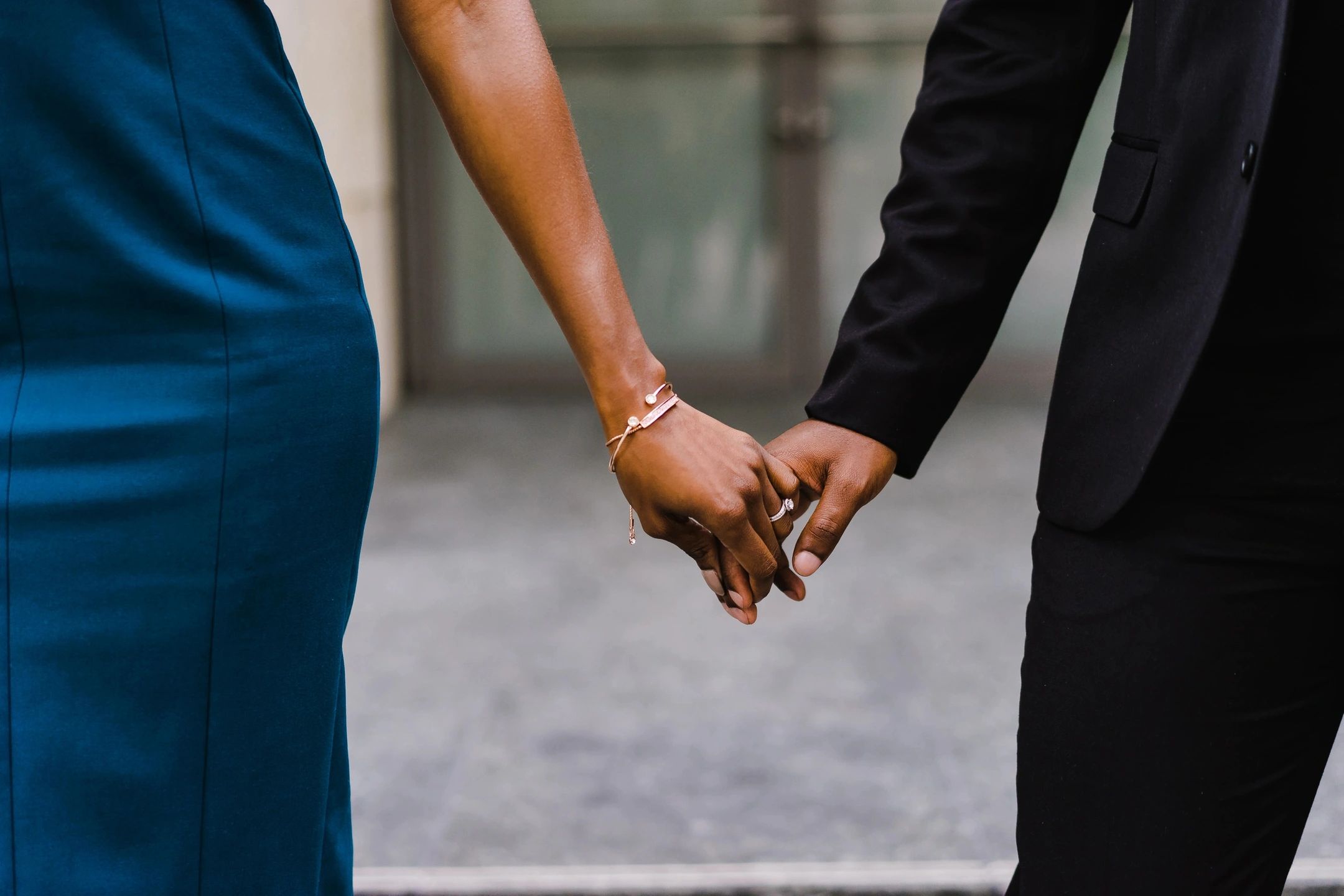 a couple holding hands showing the benefits of couples therapy